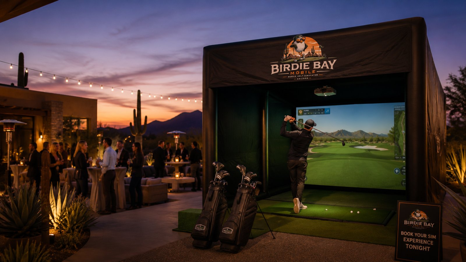 Birdie Bay Mobile golf simulator set up at an outdoor cocktail event in the Arizona desert at sunset, with guests enjoying drinks under string lights and saguaro cacti